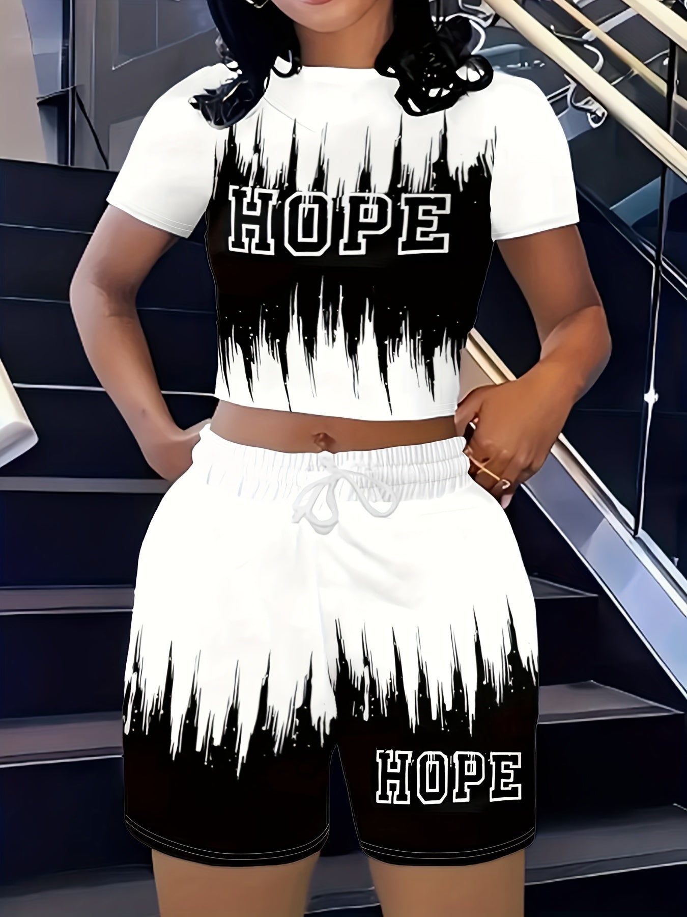 A Stylish Two-Piece Set for Women Featuring a Short-Sleeve Top with a Gradient Letter Pattern And Matching Shorts.